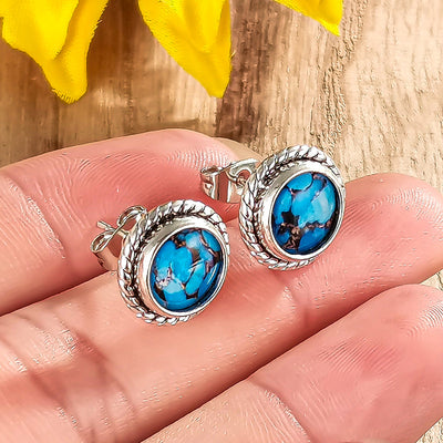antique silver tone earrings showing round turquoise color centers in rope edged settings