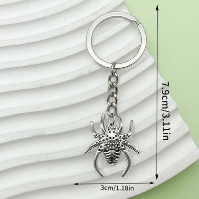 Textured spider charm keychain shown with printed length and width measurements.