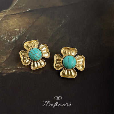 Gold flower turquoise cabochon stud earrings on dark stone
