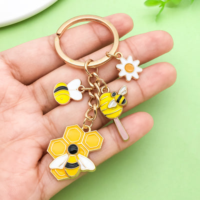 Image 1 showing a person holding a keychain with flowers.