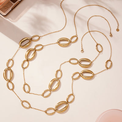 Gold oval link sweater necklace laid flat with extender chain