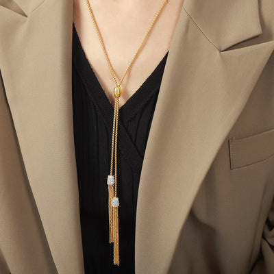 Gold Y-lariat tassel necklace with crystal caps worn on model