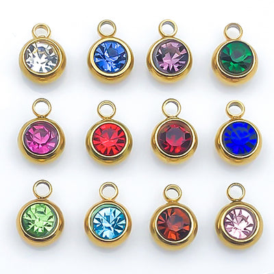 Colorful birthstone charms arranged on a light background