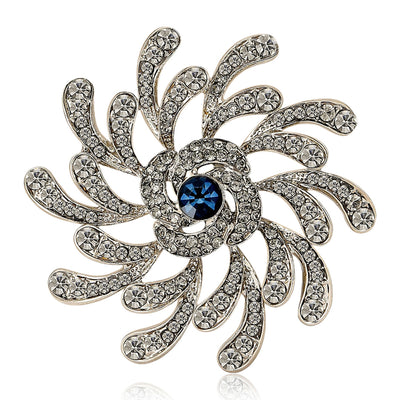 Silver spiral flower brooch clear rhinestones blue center front
