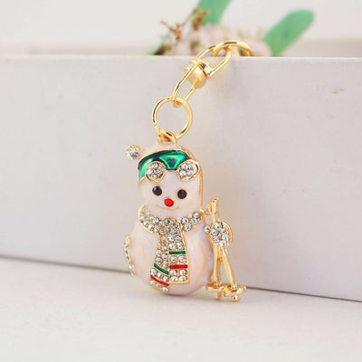 Close-up of the snowman charm hanging from a gold-tone swivel connector.