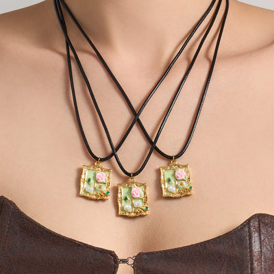 Neckline view of black cord green floral frame necklace in main image 1.