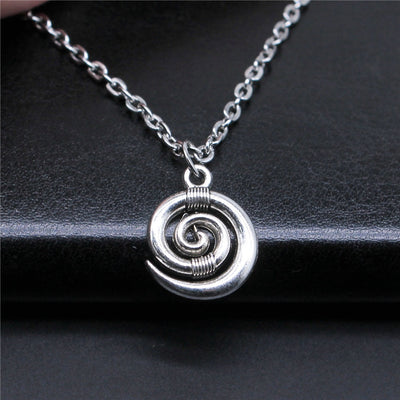 Silver Tone Spiral Pendant Necklace with Link Chain shown in image 1 with a raised spiral disc on a link chain