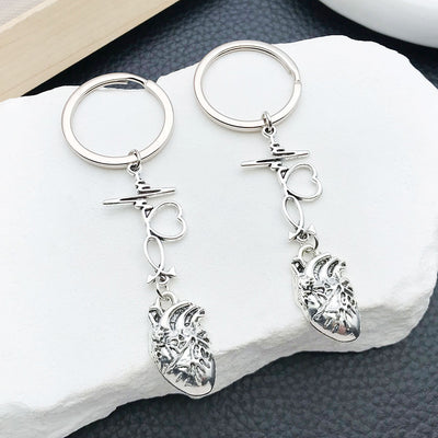 Main display of silver tone heartbeat stethoscope and anatomical heart keychain