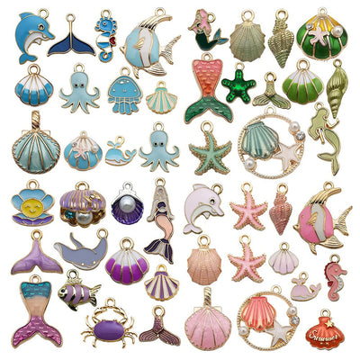Yellow seashell and starfish charms arranged on a light background