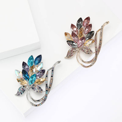 Faceted Crystal Leaf Bouquet Brooch shown against a white display background