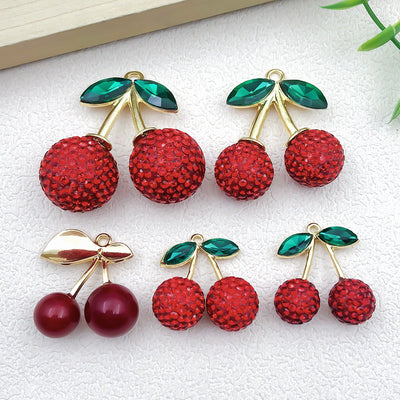 Red cherry charms arranged on a light background
