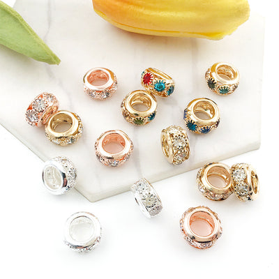 Colorful spacer bead beads arranged on a light background