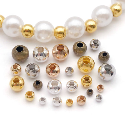 Metallic spacer bead beads arranged on a light background