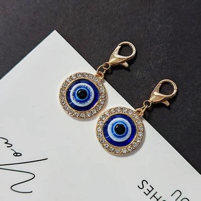 Two gold lobster clasp blue evil eye keychains with rhinestone borders