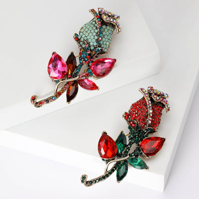 Front view of the crystal rose stem brooch with faceted petals decorative clothing pin on a white background