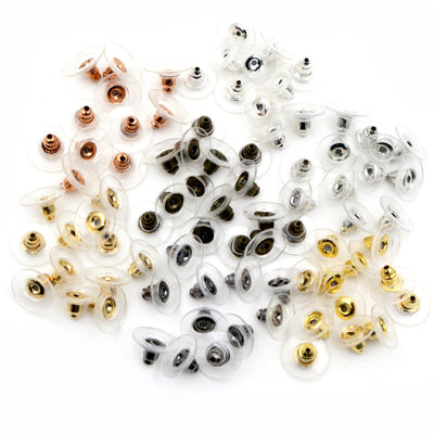 Assorted clear silicone disc earring backs with metal inserts arranged together in the main product view