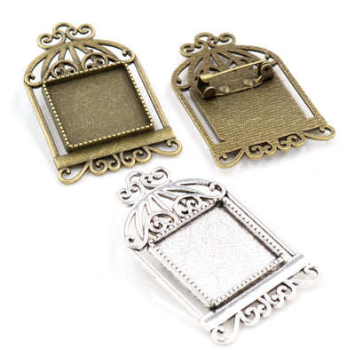 Assorted ornate birdcage square cabochon brooch blank settings arranged together in the main product view