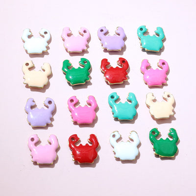 Crab charms showing assorted shapes and finishes