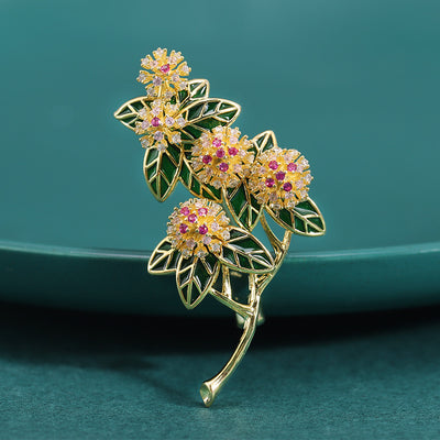 Gold Tone Floral Branch Brooch shown alone on a light background