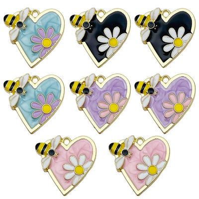 Colorful bee and daisy charms arranged on a light background