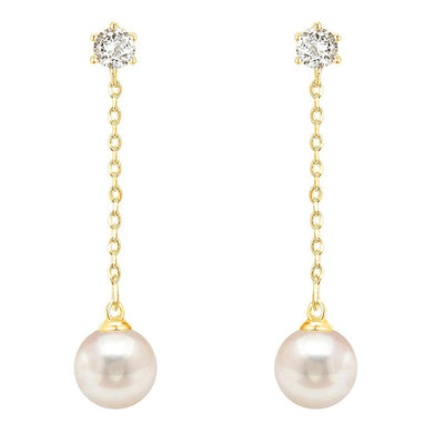Pair of gold tone pearl drop chain earrings with clear stud tops on white background