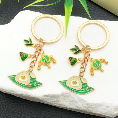 Front product photo of green dragon boat festival rice dumpling charm keychain showing the pictured design arrangement