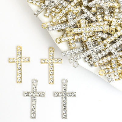 Assorted cross charms arranged on a white surface