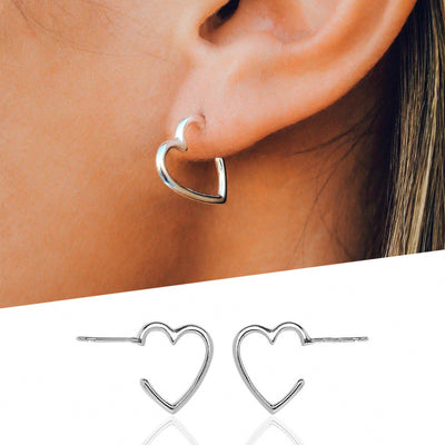 Silver open heart stud worn on ear above white product pair shot