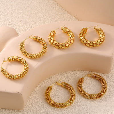 Six gold textured hoops mesh disc and bead styles on beige stand