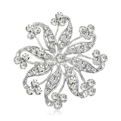 Silver openwork flower rhinestone brooch front on white