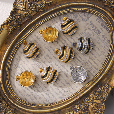 Gold and steel round pearl stripe studs in ornate tray