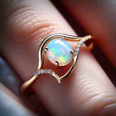 Champagne gold open swirl oval faux opal ring on finger macro view