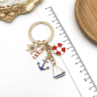 Overview showing the available color and design variations of the red blue nautical lighthouse anchor and sailboat keych