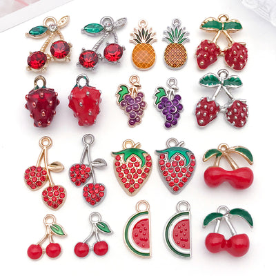 Colorful strawberry and cherry charms arranged on a light background