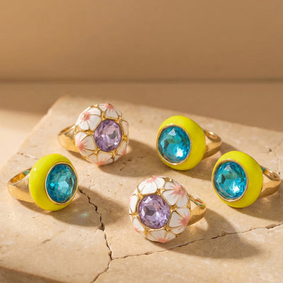 Grouped style view of enamel and faceted glass statement rings in main image 1.