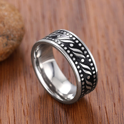Steel flame leaf dot band ring standing on wood with stone