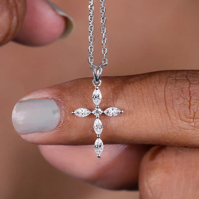 Front view of silver marquise CZ cross pendant on finger