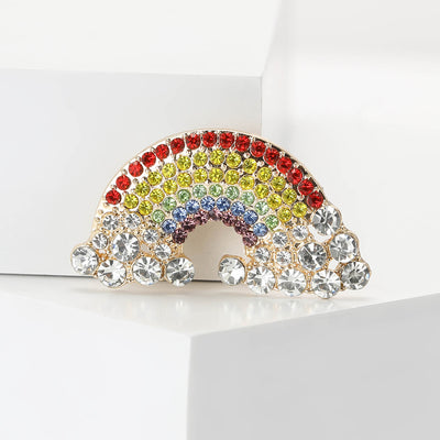 Front view of the rainbow brooch showing a rainbow of red, yellow and blue crystals with clear crystal clouds