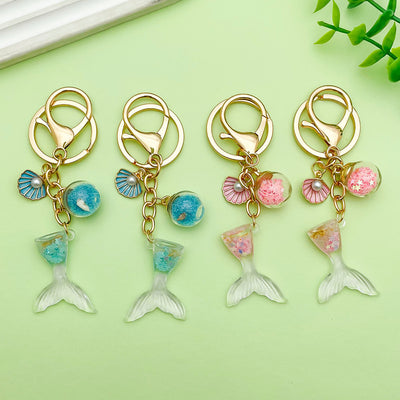 Image 1 showing mermaid keychain with charms.