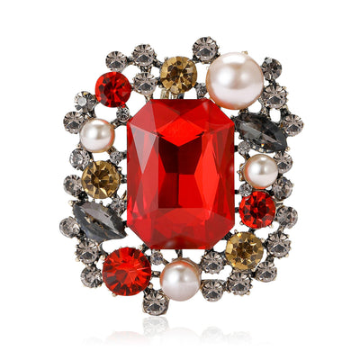 Front view of a large rectangular center stone framed by pearls and small crystals