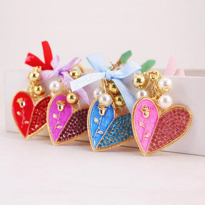 Four heart keychains in red, purple, blue, and pink arranged together.