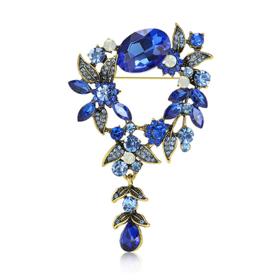 Product display showing a dark metal wreath of crystal leaves with a dangling teardrop