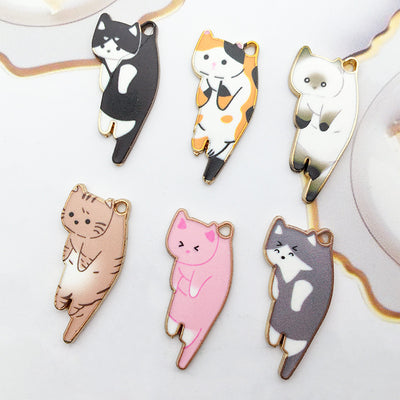 Colorful cat charms arranged on a light background