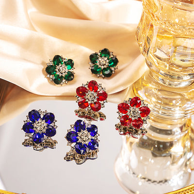 Red sapphire and green rhinestone flower studs on silk with glass vase