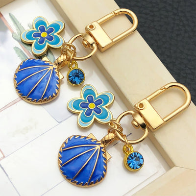 Overview showing the available color and design variations of the blue pink shell flower metal clasp keychain