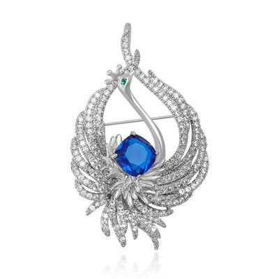 Blue center silver pave peacock brooch front on white background