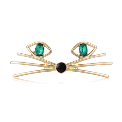 Gold cat whiskers face brooch with green crystal eyes