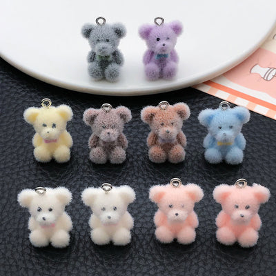 Multicolor bear charms arranged on a light background