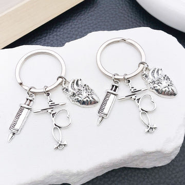 Two Silver Tone Syringe Stethoscope and Heart Keychains