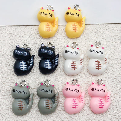 Multicolor cat charms arranged on a light background